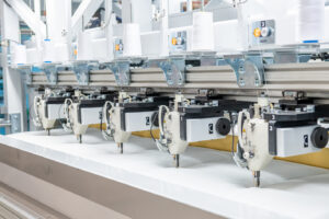 The quilting module is equipped with twelve modified servo-driven lock stitch sewing heads.